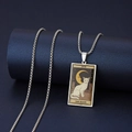 Macro shot of silver stainless steel Tarot Moon necklace with white cat and starry sky design - The Moon