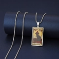 Macro shot of stainless steel The Magician tarot pendant featuring a black cat design - The Magician
