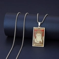 Macro detail of The Emperor cat tarot pendant made of vintage stainless steel with box chain - The Emperor