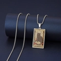 Macro detail of The Hierophant black cat tarot card pendant in silver stainless steel - The Hierophant