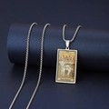 Macro shot of silver stainless steel cat Chariot tarot card necklace on a blue stand - The Chariot