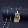 Detailed shot of IX The Hermit Tarot necklace with black cat pendant on a blue pedestal - The Hermit