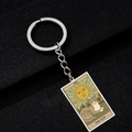 Retro Tarot The Sun card keychain with cat and sunflower on black textured surface - The Sun