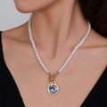 Faux pearl necklace with blue bird pendant and gold OT toggle clasp on model - Blue and White Bird Floral Style (Style 6)