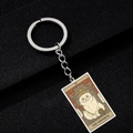 Detail of a vintage cat tarot keychain featuring The Emperor design on textured background - The Emperor