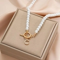 Detail of high-gloss pearl necklace featuring a gold OT clasp and crystal letter C pendant - Gold C