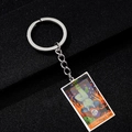 Macro detail of The Hanged Man tarot card pendant with colorful painted enamel finish - The Hanged Man