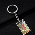 Macro detail of The High Priestess tarot card keychain with colorful enamel and metal ring - The High Priestess