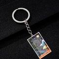 Macro detail of The Star tarot card keychain with gothic black cat and gargoyle art - Star