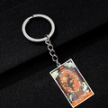 Macro shot of tarot key ring featuring The World XXI card with Halloween painting - WORLD