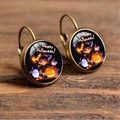 Close-up of Halloween hook earrings with cartoon witch and pumpkin on wooden background - Chibi Anime Witch and Pumpkin Ghost Style (Style-25)