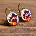 Macro shot of Halloween earrings with cartoon witch and pumpkin on wooden surface - Chibi Anime Witch with Lantern (Style-22)
