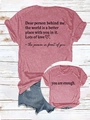 Detail of inspirational back quote and front print on brick red textured cotton t-shirt - Peach (Black Font)