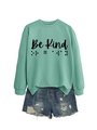 Detail of mint green sweatshirt with Be Kind text and braille dots paired with denim - Light Green (Black Text)