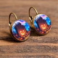 Macro shot of Halloween drop earrings with pumpkin and tombstone glass cabochon - Scary Pumpkin Lantern Tombstone Scene (Style-15)