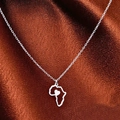 Silver Africa map pendant necklace with heart detail on brown satin background - Silver