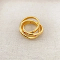 Intertwined gold triple rings with inlaid colorful zircon gems on textured beige fabric - US 8 / Gold