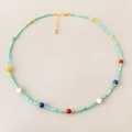 Handgemaakte kralenketting met turquoise stenen, kleurrijke kralen en goudkleurige sluiting - Blauw