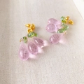 Pink quartz and green glass berry earrings with gold plating on a textured fabric - Pink