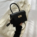 Classic black leather flap bag with gold square twist lock and top handle - Black