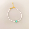 Detailed shot of a handmade beaded bracelet with white beads and a turquoise square center - Amazonite Bracelet