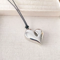 Minimalist silver heart pendant necklace with polished asymmetric design on black cord - Platinum Gold (Length approx 92cm)
