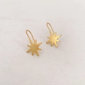 Vintage matte gold star earrings featuring an eight-pointed North Star dangle design - Star Style