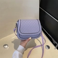 Lavender woven saddle bag with adjustable strap and chic textured flap for daily wear - Purple