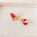 Detail of handmade gold earrings featuring red dried flowers inside transparent resin hoops - Gold Hoop Red Dried Flower Style / Red