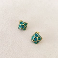 Detailed shot of gold-framed square enamel earrings with vintage turquoise crackle patterns - Teal