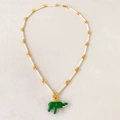 Detail of green enamel elephant pendant on ivory cylindrical beaded bamboo chain - Beige Chain + Green Elephant