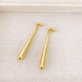 Macro shot of minimalist gold teardrop earrings on soft textured fabric background - Gold