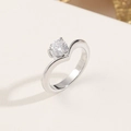 Elegant wave-shaped titanium steel ring with a round brilliant cubic zirconia stone - US 5 / Silver