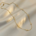 Minimalist gold beaded snake chain necklace in stainless steel on silk background - Round Snake Bead Chain