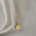 Macro detail of golden Fu character pendant on silk fabric with elegant fine link chain - Single-sided Fu Necklace - Gold