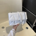 White geometric quilted shoulder bag with silver chain strap and minimalist design - White