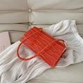 Fashionable bright orange crocodile pattern leather baguette bag with a glossy finish - Orange