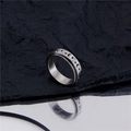 Silver stainless steel rotating ring with moon and star engraving on textured background - US 7 / Steel
