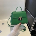 Emerald green leather crossbody bag with a distinctive golden T-bar metal rotating lock - Green