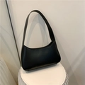 Minimalist black faux leather underarm bag with sleek crescent shape and shoulder strap - Black