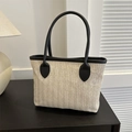 Minimalist woven straw bucket tote bag with black leather handles and contrast trim - Black