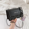 Chic black chain shoulder bag with wave-edge flap and silver metallic ball charm - Black