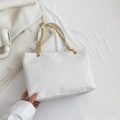 White quilted tote bag with geometric texture and gold chain strap on soft fabric - White