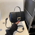 Classic black leather crossbody handbag with gold D-ring buckle and top handle - Black