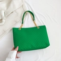 Green woven texture tote bag with metallic chain handle on a minimalist white fabric - Green