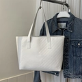 Detail of white tote bag featuring premium V-shaped quilting and smooth PU leather texture - White Upright Chevron