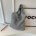 Metallic silver knit tote bag with sparkling thread texture for a stylish winter look - Silver