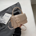 Chic beige textured crossbody bag with decorative resin buckle and top handle design - Khaki