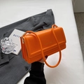 Classic bright orange rectangular shoulder bag with elegant gold hardware and top handle - Orange