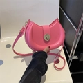Chic pink crescent saddle bag with gold circular buckle and adjustable leather strap - Rose Pink